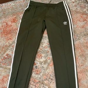 Army green adidas track pants